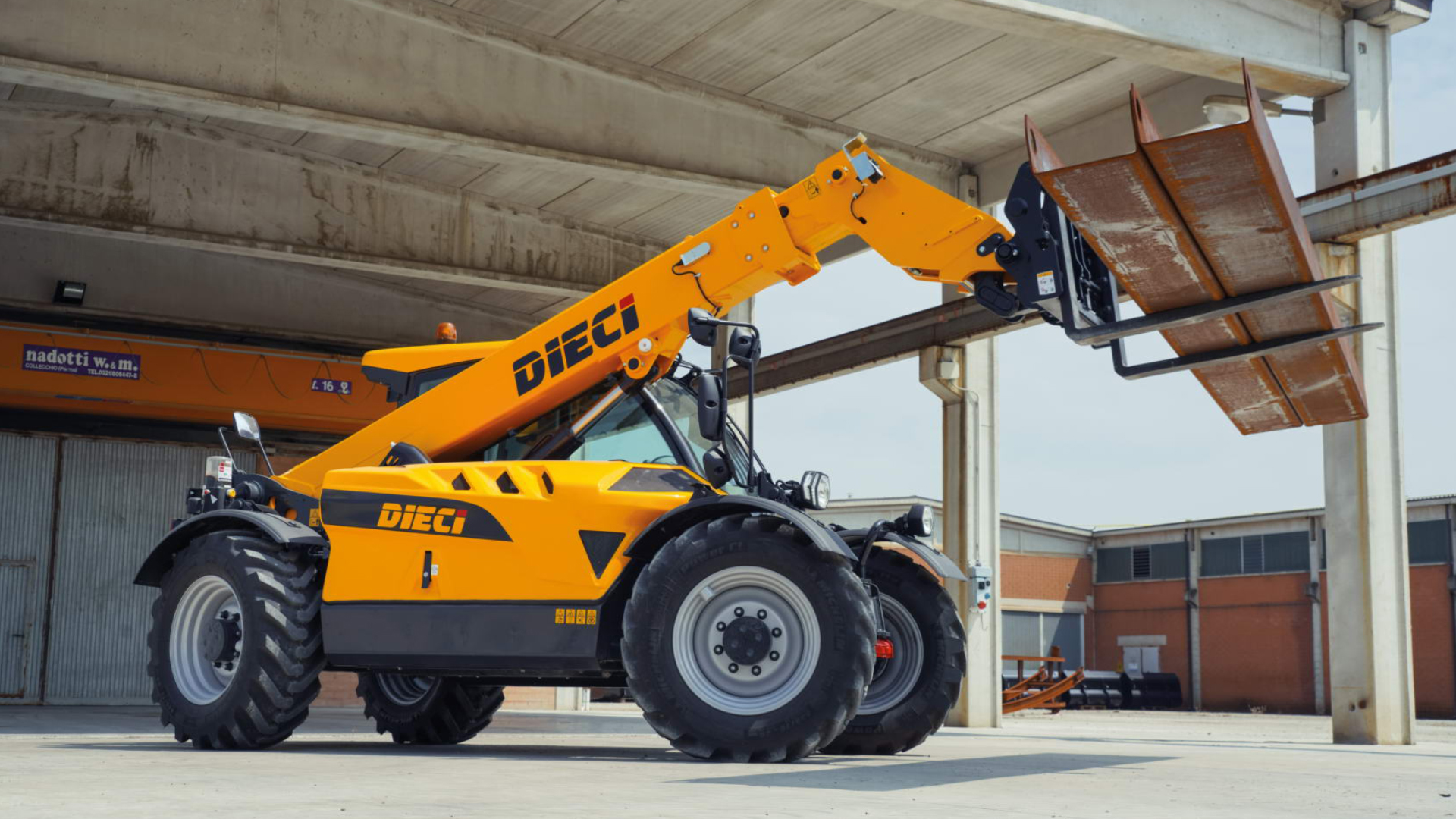 Image shows a Dieci telehandler in a Construction Infrastructure environment holding two steel beams