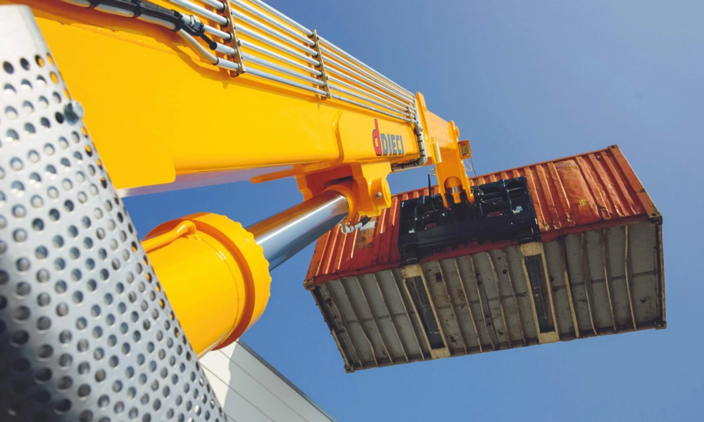 Telehandler boom raised lifting a shipping container
