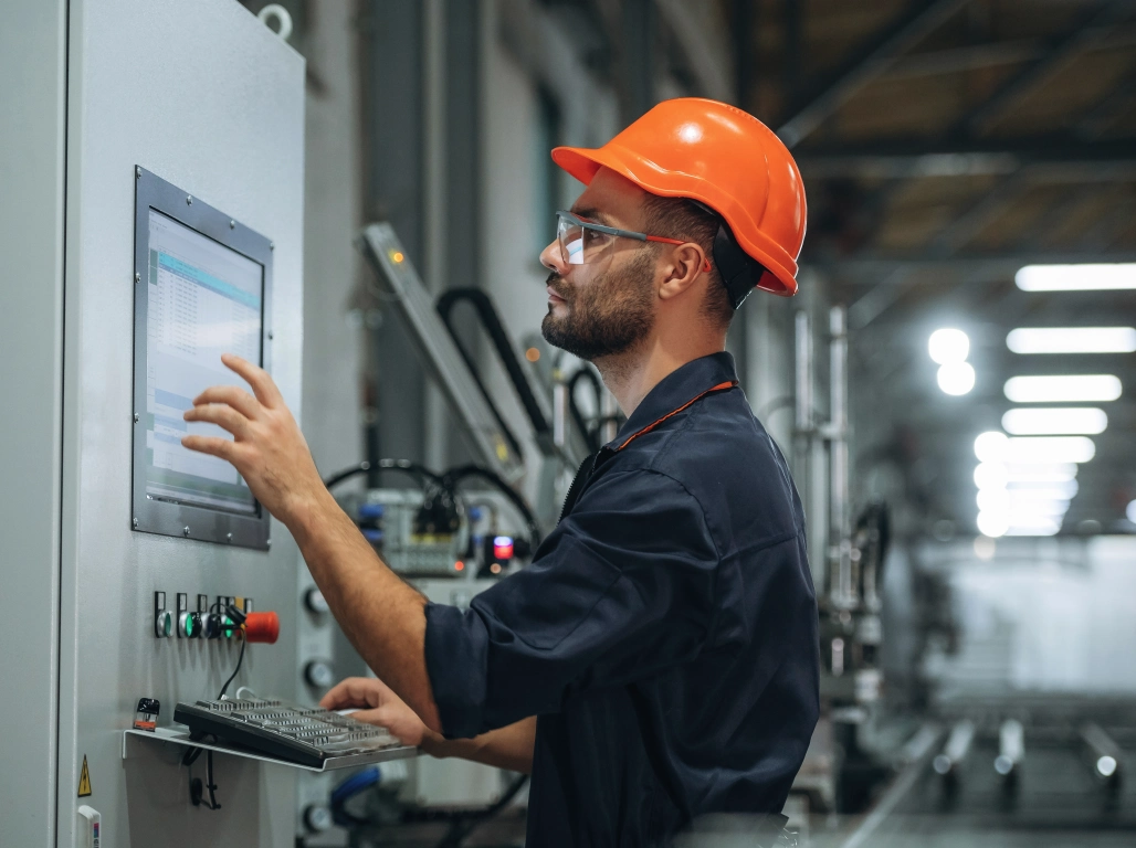 factory worker operating a machine to build dieci telehandlers and trucks