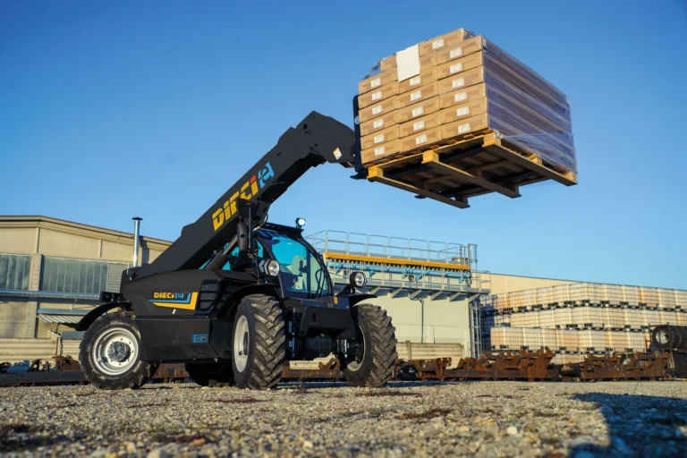 Dieci Apollo-e 2.6T electric telehandler lifting a heavy pallet of materials