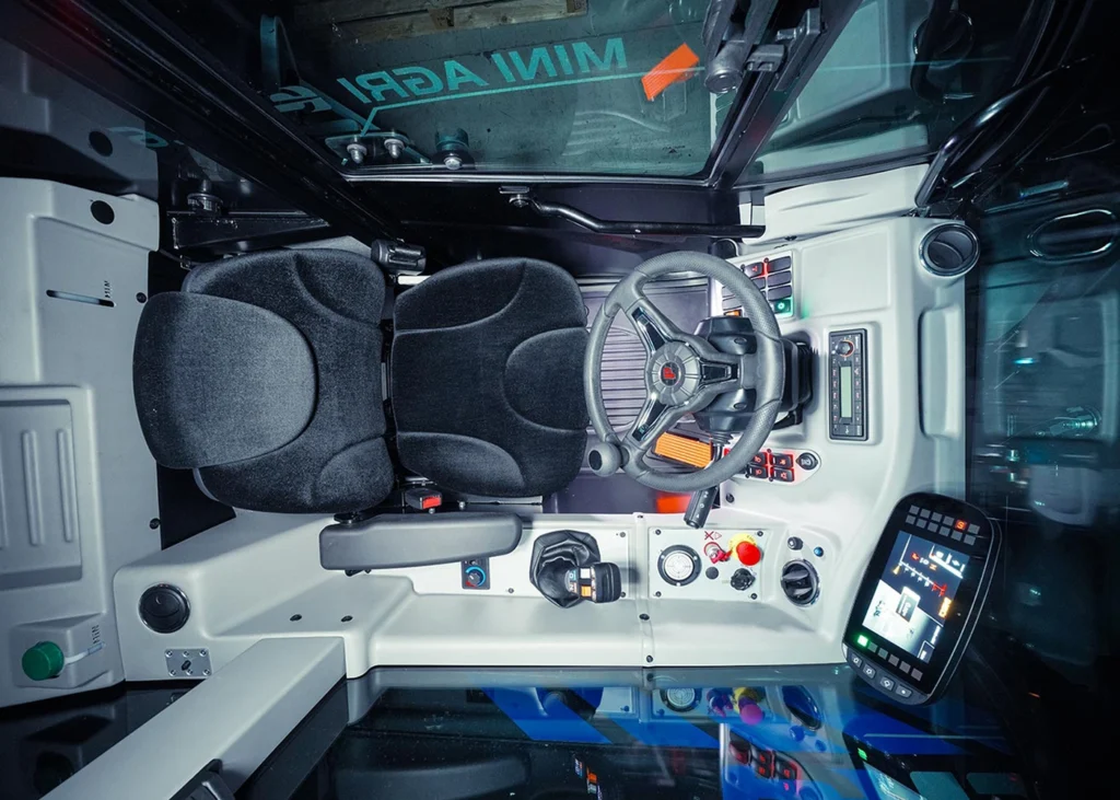 Interior view of the apollo-e electric telehandler showing the seat and controls