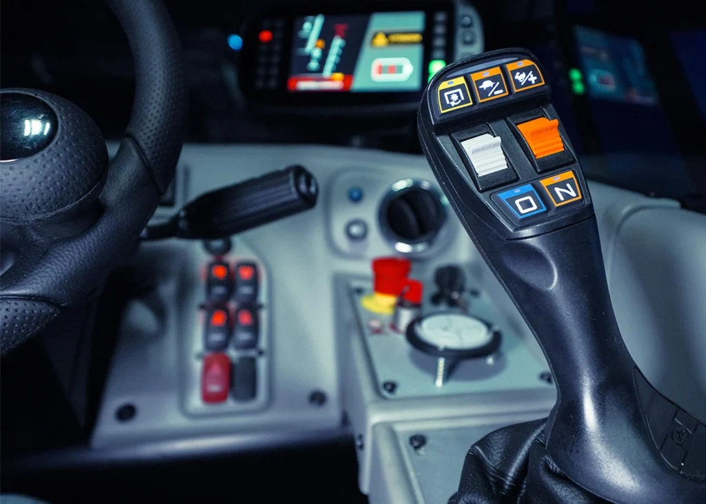 Interior view of the apollo-e electric telehandler showing the joystick controls