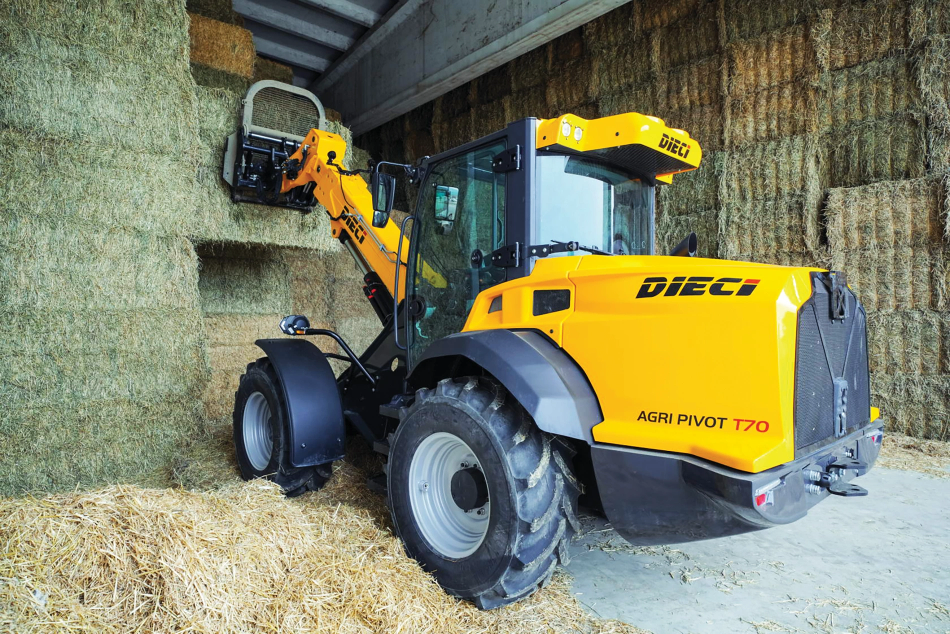 dieci agri pivot t70 articulated telehandler working in a farm shed to move hay bales