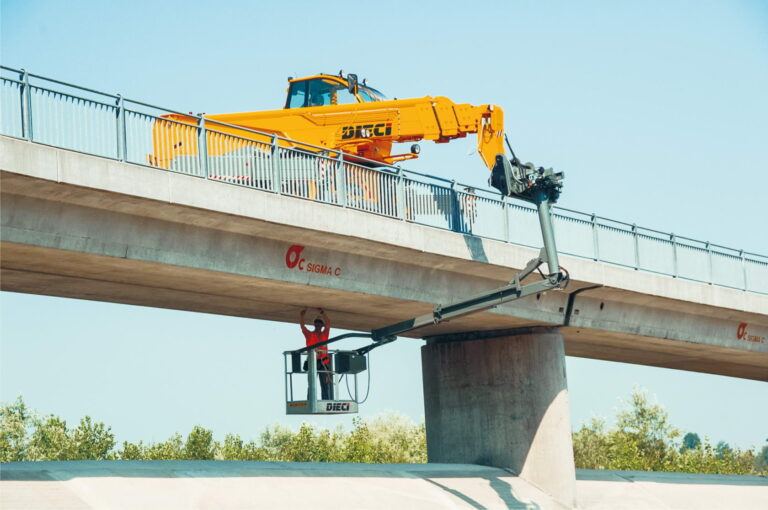Pegasus 50.21 rotating telehandler working on a bridge with an EWP elevated work platform