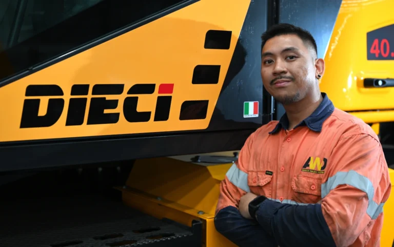a Dieci service technician next to a telehandler
