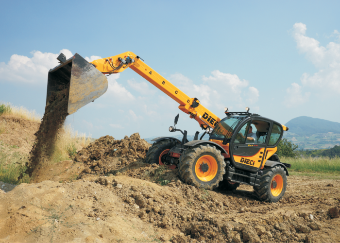 left side view of the Zeus 40.7 4T Telehandler with its boom extended tipping out a bucket of dirt on an Australian construction site