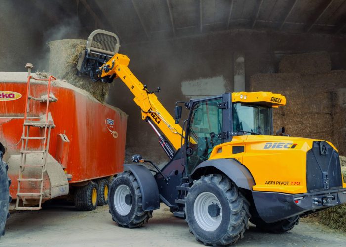 left rear view of an Agri Pivot T70 3t Telescopic Loader pouring farm materials onto a truck