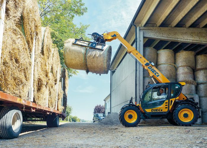 left side view of the Agri Farmer 30.9 3t Agricultural Telehandler loading hay bales onto a truck in regional Australia