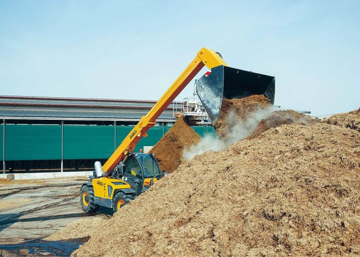 Agri Max 7t Telehandler emptying its bucket of dirt and hay