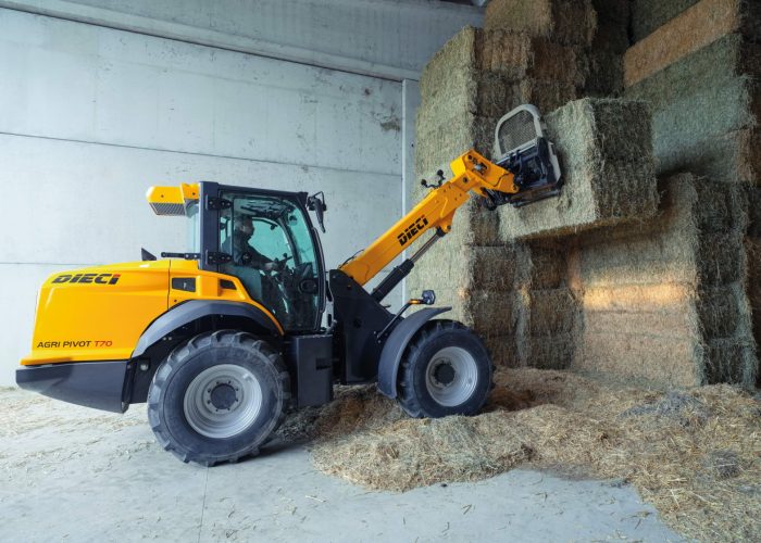 right side view of a Agri Pivot T70 3t Telescopic Loader placing hay bales in a shed in Australia