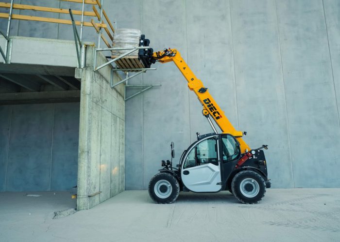 front side view of Dieci Apollo 25.6 2.5t Telehandler lifting a heavy load of construction materials up high in an Australian warehouse