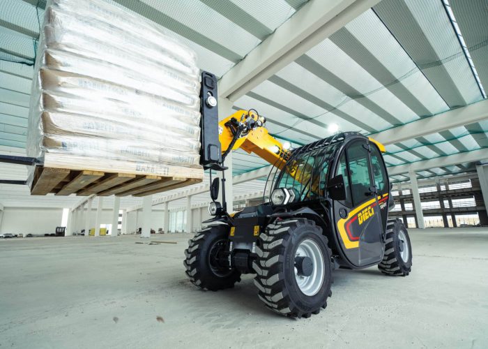 Apollo Smart 20.4 2t Compact Telehandler carrying 2tonnes of building materials inside a building warehouse in Sydney Australia