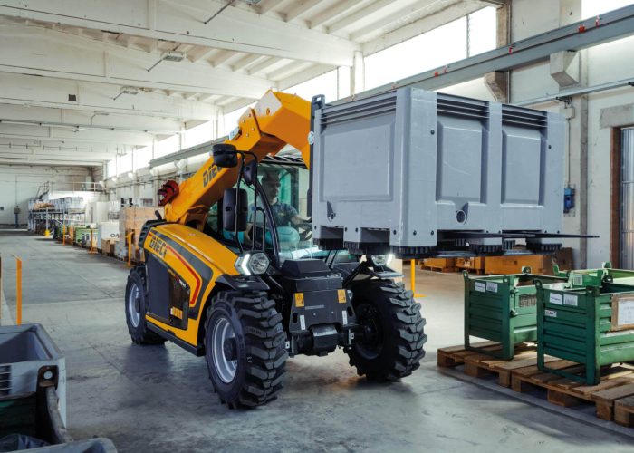 Apollo Smart 20.4 2t Compact Telehandler carrying a heavy load on a pallet at a construction site in Australia