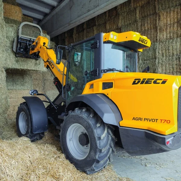 Image shows a Dieci Agri Pivot T70 telehandler loading hay bales in a tight enclosed farm shed