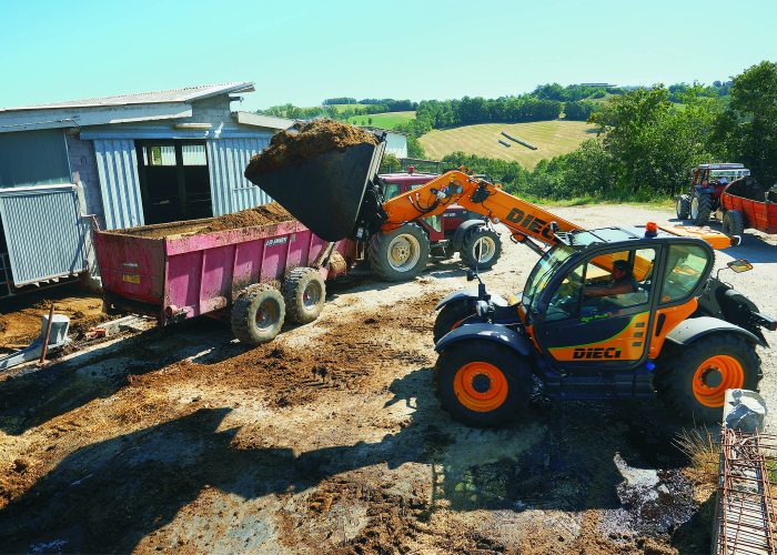side view of Agri Plus 40.7 4t Telehandler lifting 4 tonnes of farm supplies into a truck in Brisbane, Australia