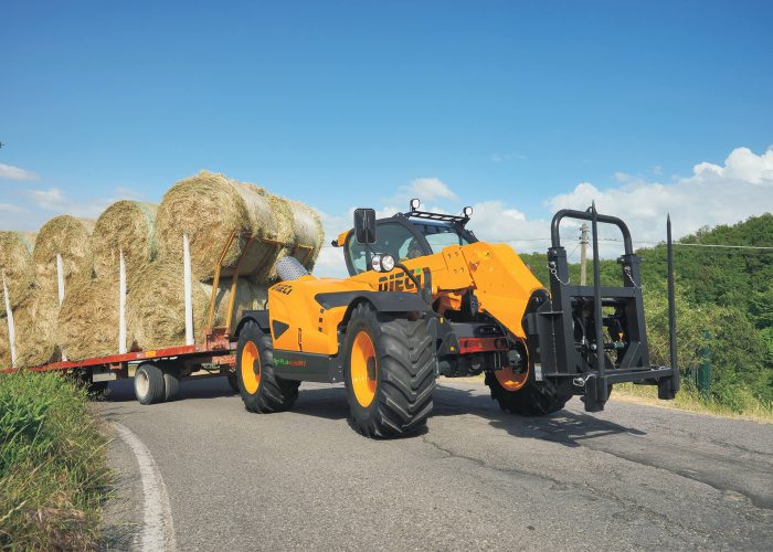 Agri Plus 40.7 4t Telehandler towing a trailer of farm supplies on a road in regional NSW