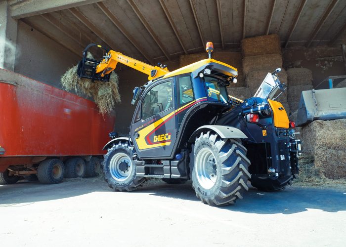 left side view of a Agri Plus GD 4.2t Telehandler loading hay and feed into the back of a truck