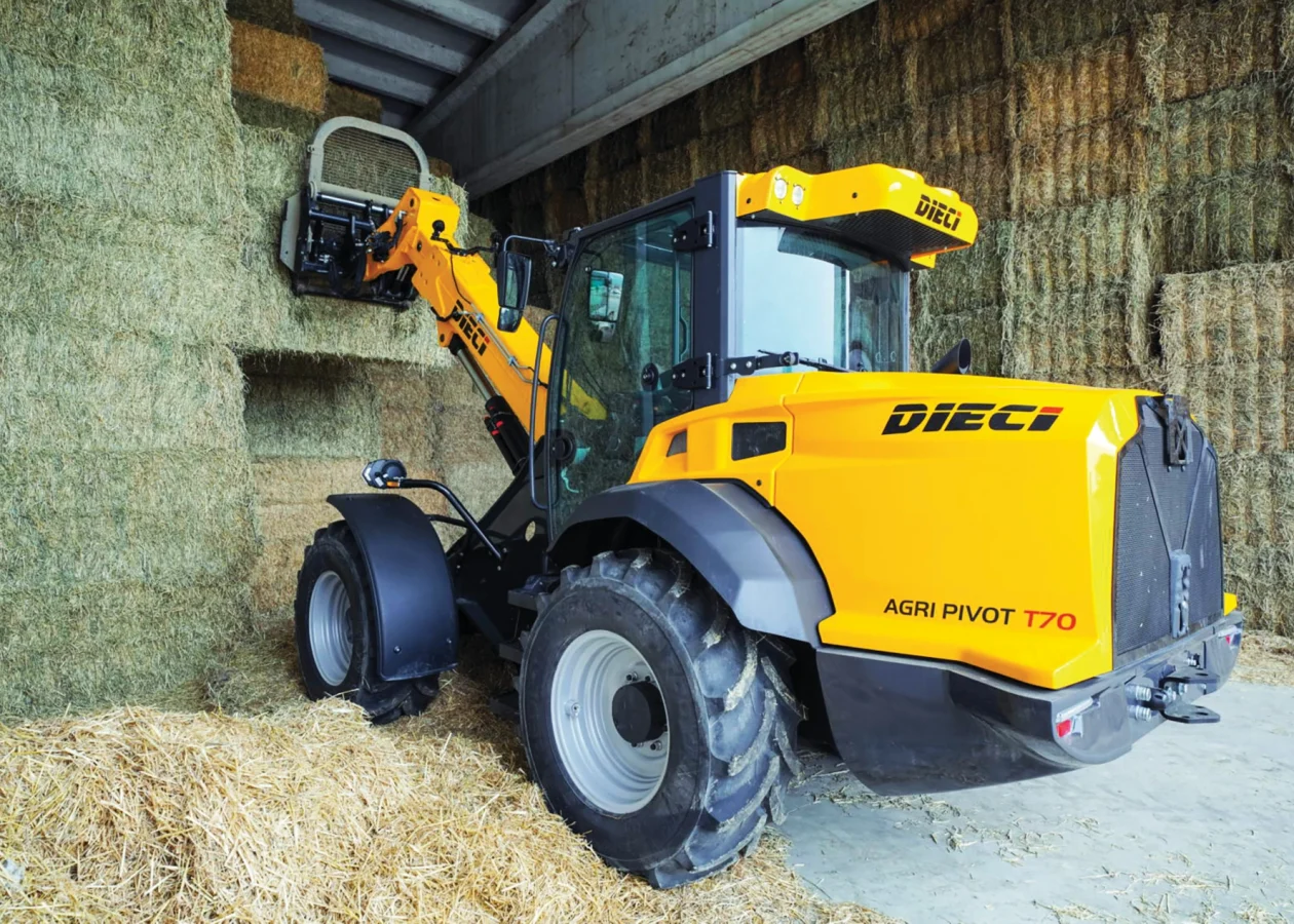 dieci agri pivot t70 articulated telehandler working in a farm shed to move hay bales
