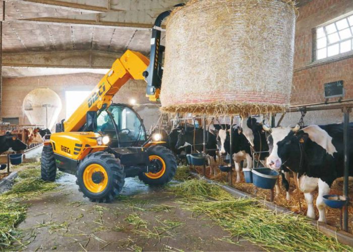 Mini Agri 2.5t Agricultural Telehandler in a cow shed holding a hay bale feeding livestock on an Australian farm