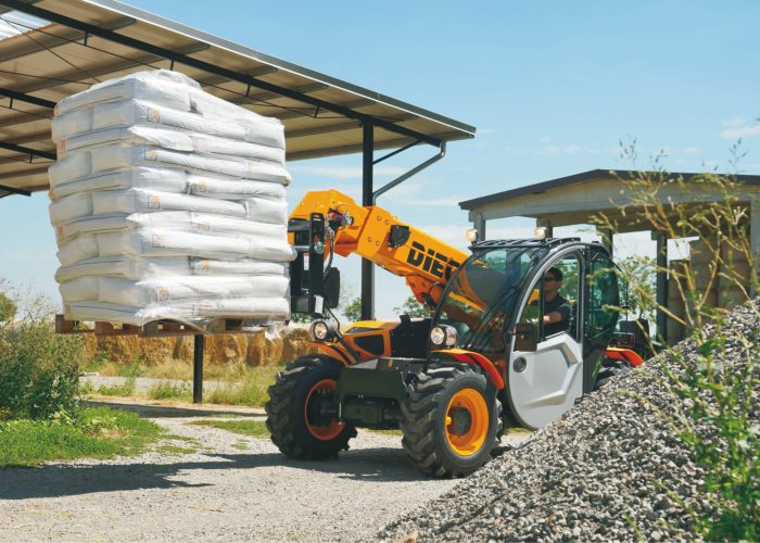 Front left view of a Mini Agri 2.5t Agricultural Telehandler lifting 2.5 tonnes of agricultural supplies on an Australian farm