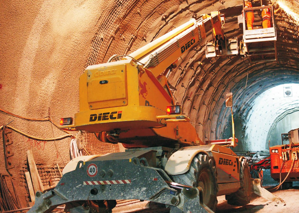 Dieci Construction equipment in a tunnel, with a worker elevated on a platform.