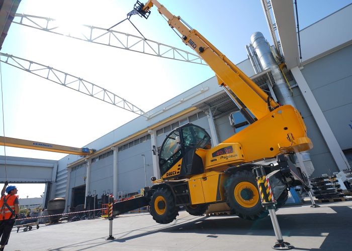 Dieci Pegasus 400° 3.8t Rotating Telehandler with its stabiliser legs deployed performing a heavy lift on a construction site in Perth, Australia