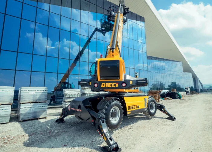 rear side view of a Dieci Pegasus 60.21 6t rotating telehandler with its boom raised and outriggers deployed