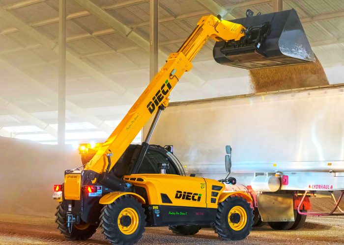 Poultry Pro 3t Telehandler tipping a large load of materials into a waiting truck