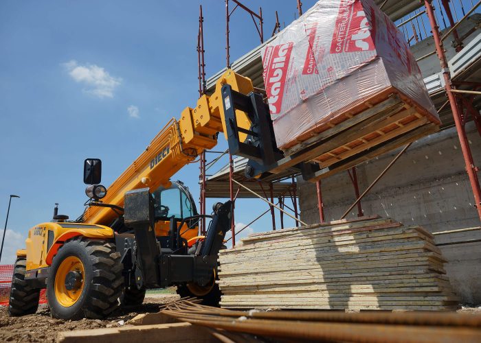 front right side view of a Dieci Runner 40.13 4T Telehandler placing heavy building materials on an Australian construction site