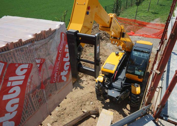 front top down view of a Dieci Runner 40.13 4T Telehandler placing a pallet of heavy building materials on a building site in Australia